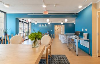 A conference room with a long table and chairs.